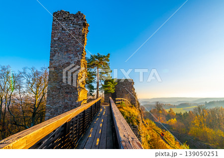 Ruin of castle Zubstejn standing on hill, Czech Republic. Castle built in 13 th century. Autumn day during the sunset. One of biggest ruins in Czechia. Also known as Zuberstein or Zubstein. 139050251