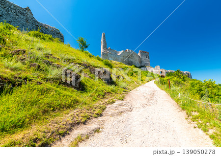 The old ruins of castle Cachtice (Cachtice in local speak). Ruined castle on top of hill at Slovakia. Famous and mysterious place known from legend of blood lady Bathory. Summer day, panorama view. 139050278