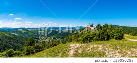 The old ruins of castle Cachtice (Cachtice in local speak). Ruined castle on top of hill at Slovakia. Famous and mysterious place known from legend of blood lady Bathory. Summer day, panorama view. 139050288