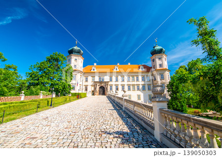 Historical chateau at Mnisek pod Brdy city, Czech Republic. View of ancient building with towers, built in gothic style. Sunny summer day, blue sky and vibrant colors. Historical chateau at Mnisek pod Brdy city, Czech Republic. View of ancient building with towers, built in gothic style. Sunny summer day, blue sky and vibrant colors. 139050303
