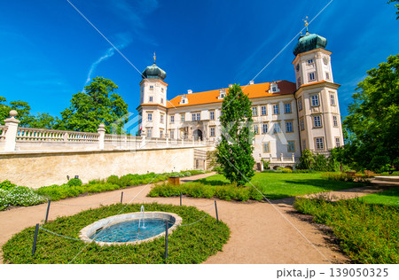 Historical chateau at Mnisek pod Brdy city, Czech Republic. View of ancient building with towers, built in gothic style. Sunny summer day, blue sky and vibrant colors. Historical chateau at Mnisek pod Brdy city, Czech Republic. View of ancient building with towers, built in gothic style. Sunny summer day, blue sky and vibrant colors. 139050325