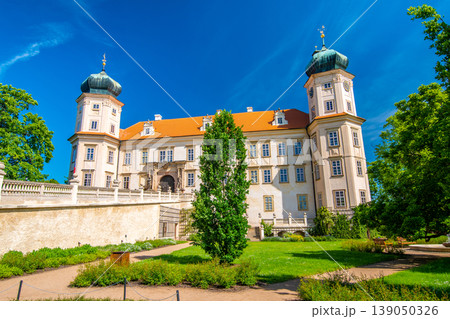 Historical chateau at Mnisek pod Brdy city, Czech Republic. View of ancient building with towers, built in gothic style. Sunny summer day, blue sky and vibrant colors. Historical chateau at Mnisek pod Brdy city, Czech Republic. View of ancient building with towers, built in gothic style. Sunny summer day, blue sky and vibrant colors. 139050326