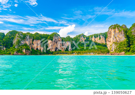 Panoramic view of Railay beach at Krabi town, Thailand. View from sea side to big limestone rocks with green jungle. Pure and vibrant turquoise water in foreground. Tropical paradise, famous vacation 139050627