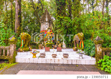 Memorial shrine at Doi Inthanon tropical rainforest park. Elephant statues on the sides as memento of king visit Memorial shrine at Doi Inthanon tropical rainforest park. Elephant statues on the sides as memento of king visit 139050711