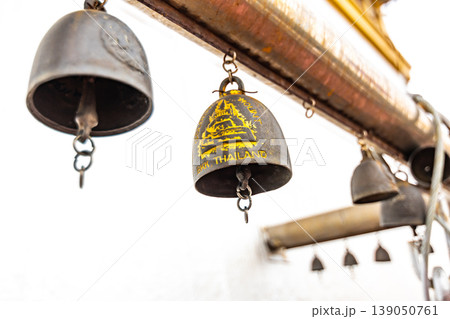 Bells on the top of Wat Saket temple (Golden mount) in Bangkok, Thailand. Religion bells are buddhist symbol of religion. Famous tourist destination. Oriental symbol of Asia culture Bells on the top of Wat Saket temple (Golden mount) in Bangkok, Thailand. Religion bells are buddhist symbol of religion. Famous tourist destination. Oriental symbol of Asia culture 139050761