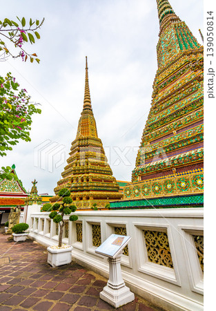 Closeup view of beautiful ceramic tiled stupa in Wat Pho temple, Bangkok, Thailand. Pagoda in oriental asian style is created from ceramic tiles. Famous tourist destination. Cloudy weather. 139050814