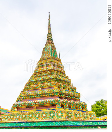 Closeup view of beautiful ceramic tiled stupa in Wat Pho temple, Bangkok, Thailand. Pagoda in oriental asian style is created from ceramic tiles. Famous tourist destination. Cloudy weather. Closeup view of beautiful ceramic tiled stupa in Wat Pho temple, Bangkok, Thailand. Pagoda in oriental asian style is created from ceramic tiles. Famous tourist destination. Cloudy weather. 139050815