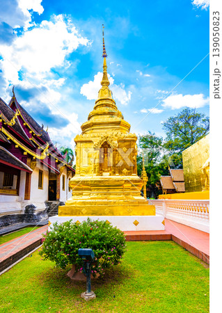 Beautiful view of Wat Phra Singh temple with golden chedi stupa and pagoda in Chiang Mai city, Thailand. Symbol of buddhism and ancient spirituality. Famous tourist destination. Summer weather Beautiful view of Wat Phra Singh temple with golden chedi stupa and pagoda in Chiang Mai city, Thailand. Symbol of buddhism and ancient spirituality. Famous tourist destination. Summer weather 139050823