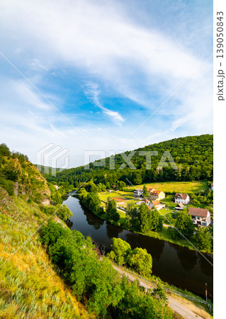 River near the meadow and forest. Idyllic view of peaceful nature, sunset colors River near the meadow and forest. Idyllic view of peaceful nature, sunset colors 139050843