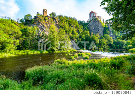 View of beautiful castle Vranov nad Dyji, Moravian region in Czech republic. Ancient chateau built in baroque style, placed on big rock above river near the Vranov village. Cloudy weather. View of beautiful castle Vranov nad Dyji, Moravian region in Czech republic. Ancient chateau built in baroque style, placed on big rock above river near the Vranov village. Cloudy weather. 139050845