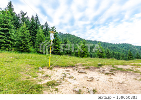 Tourist pointer placed on meadow near Maly Rozsutec mountain in Slovakia national park Mala Fatra. "Pod Tanecnicou" translation: Under the dancer peak. "Tanecnicou" is the name of near mountain. 139050883