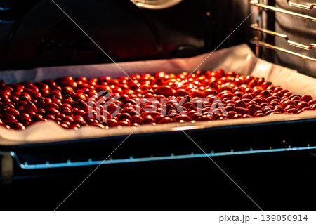 Rose hips (latin name Fructus cynosbati) are drying in oven. Dried rose hips are important source of vitamins in alternative medicine. Colorful image of natural and herb ingredients 139050914
