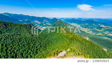Slovakia national parkland Mala Fatra - view from Maly Rozsutec mountain to nearby hills and valleys. Sunny summer day, tourism and hiking in fresh and pure nature. Forest and green trees. 139050925