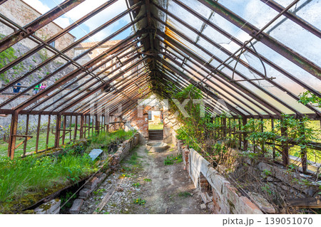 Look to old ruined greenhouse. Broken ancient greenhouse with broken windows Look to old ruined greenhouse. Broken ancient greenhouse with broken windows 139051070