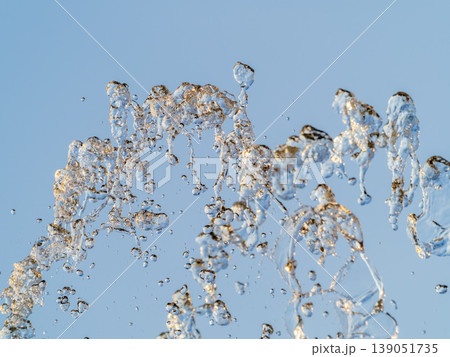 Splashes and jets of water against light background. 139051735