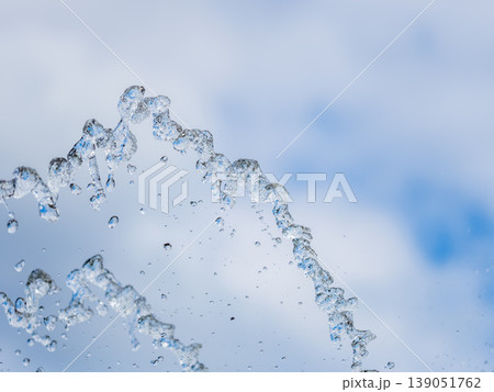 Splashes and jets of water against light background. 139051762