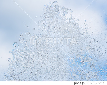 Splashes and jets of water against light background. 139051763
