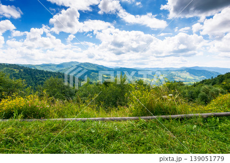 herb field in the mountain landscape in summer. wonderful view of carpathian mountains under cloudy sky. picturesque countryside landscape with forested hills. view in to the valley 139051779