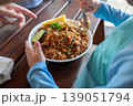 Child Enjoying a Plate of Seafood Fried Rice with Fresh Vegetables and Lemon 139051794