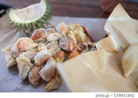 Delicious Durian Fruit and Seeds Served at a Buffet in a Vibrant Market Setting Delicious Durian Fruit and Seeds Served at a Buffet in a Vibrant Market Setting 139051802