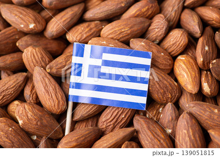 Small flag of Greece in almonds. Origin of nuts, agribusiness of growing almond in Greece Small flag of Greece in almonds. Origin of nuts, agribusiness of growing almond in Greece 139051815