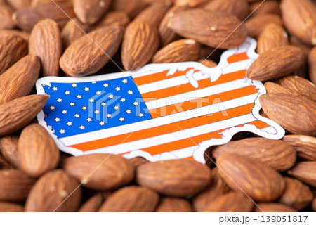 Small flag and map of USA in almonds. Agribusiness of growing almonds in USA concept 139051817