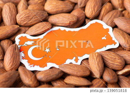 Small flag and map of Turkey in almonds. Agribusiness of growing almonds in Turkey concept Small flag and map of Turkey in almonds. Agribusiness of growing almonds in Turkey concept 139051818