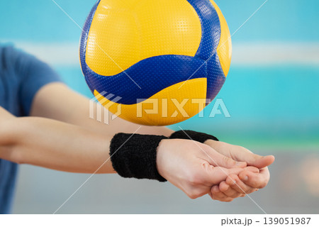 Close up of hands of a girl learning volleyball essential skills - digging. Volleyball female player practicing digging in volleyball game Close up of hands of a girl learning volleyball essential skills - digging. Volleyball female player practicing digging in volleyball game 139051987