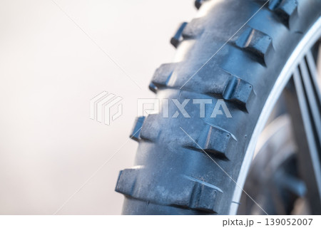 Worn tires on Enduro motorcycle, close up, copy space on the left. Care and renovation of the vehicle, speed, travel and enjoyment concepts 139052007