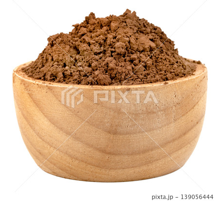 Fine cocoa powder overflowing in a rustic wooden bowl isolated. High quality ingredient for baking, chocolate making, and hot cocoa drinks. Natural and organic food concept. Fine cocoa powder overflowing in a rustic wooden bowl isolated. High quality ingredient for baking, chocolate making, and hot cocoa drinks. Natural and organic food concept. 139056444