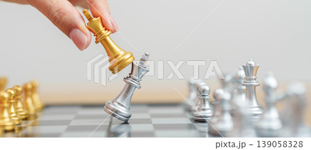 hand moving gold Chess King figure and Checkmate opponent during chessboard competition. Strategy, Success, management, business planning, win, disruption, Trade war and leadership concept hand moving gold Chess King figure and Checkmate opponent during chessboard competition. Strategy, Success, management, business planning, win, disruption, Trade war and leadership concept 139058328