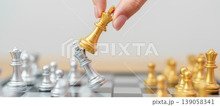 hand moving gold Chess King figure and Checkmate opponent during chessboard competition. Strategy, Success, management, business planning, win, disruption, Trade war and leadership concept hand moving gold Chess King figure and Checkmate opponent during chessboard competition. Strategy, Success, management, business planning, win, disruption, Trade war and leadership concept 139058341