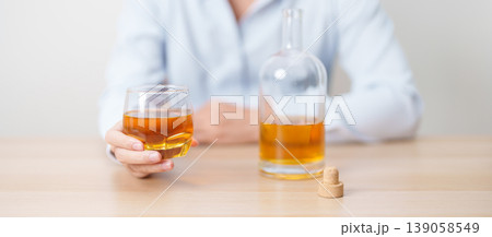 man with glass of whiskey on table, suffering from alcohol addiction and alcoholism concept. depicting emotional distress, depression, substance abuse problem, unhealthy lifestyle and mental health man with glass of whiskey on table, suffering from alcohol addiction and alcoholism concept. depicting emotional distress, depression, substance abuse problem, unhealthy lifestyle and mental health 139058549