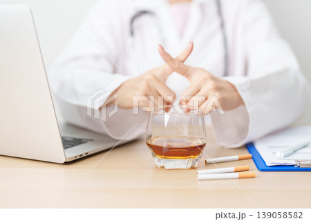 doctor hand making stop sign to refuse whiskey and breaking cigarette, quit smoking and drinking for healthy liver and lung, World No Tobacco and  No Alcohol Day and stop alcohol addiction concept 139058582