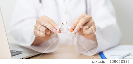 doctor hand making stop sign to refuse and breaking cigarette, quitting smoking for healthy lungs, prevent Lung Cancer and Emphysema, World No Tobacco Day concept doctor hand making stop sign to refuse and breaking cigarette, quitting smoking for healthy lungs, prevent Lung Cancer and Emphysema, World No Tobacco Day concept 139058585