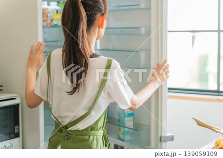 料理,自炊,冷蔵庫から食材を取り出す中高年の女性 139059109