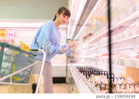 スーパーで商品を選ぶ女性 139059248