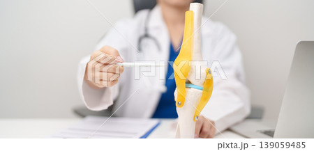 Doctor with Human Knee joint anatomy model. Osteoarthritis, Patellofemoral Pain Syndrome, Patellar Tendinitis, ACL, Anterior Cruciate Ligament, PCL, Posterior, MCL, Medial Collateral, LCL and Lateral Doctor with Human Knee joint anatomy model. Osteoarthritis, Patellofemoral Pain Syndrome, Patellar Tendinitis, ACL, Anterior Cruciate Ligament, PCL, Posterior, MCL, Medial Collateral, LCL and Lateral 139059485