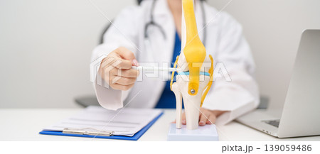 Doctor with Human Knee joint anatomy model. Osteoarthritis, Patellofemoral Pain Syndrome, Patellar Tendinitis, ACL, Anterior Cruciate Ligament, PCL, Posterior, MCL, Medial Collateral, LCL and Lateral Doctor with Human Knee joint anatomy model. Osteoarthritis, Patellofemoral Pain Syndrome, Patellar Tendinitis, ACL, Anterior Cruciate Ligament, PCL, Posterior, MCL, Medial Collateral, LCL and Lateral 139059486