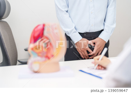 Doctor with Male Reproductive System anatomy model. Male consultation, Prostate Cancer, Enlarged prostate, Prostatitis disease, Male Infertility, Erectile dysfunction, Penis and Male genital disorder Doctor with Male Reproductive System anatomy model. Male consultation, Prostate Cancer, Enlarged prostate, Prostatitis disease, Male Infertility, Erectile dysfunction, Penis and Male genital disorder 139059647