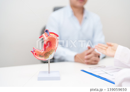 Doctor with Gastric anatomy model. Gastroenterologist consultation, stomach diseases and ulcers, November stomach cancer, Gastroesophageal Reflux Disease, GERD, Acid reflux and healthcare medical Doctor with Gastric anatomy model. Gastroenterologist consultation, stomach diseases and ulcers, November stomach cancer, Gastroesophageal Reflux Disease, GERD, Acid reflux and healthcare medical 139059650