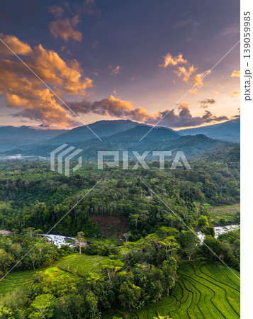 Beautiful morning view in Indonesia, panoramic landscape of rice fields with mountain ranges and clear sky Beautiful morning view in Indonesia, panoramic landscape of rice fields with mountain ranges and clear sky 139059985