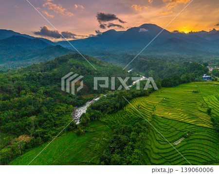 Beautiful morning view in Indonesia, panoramic landscape of rice fields with mountain ranges and clear sky Beautiful morning view in Indonesia, panoramic landscape of rice fields with mountain ranges and clear sky 139060006