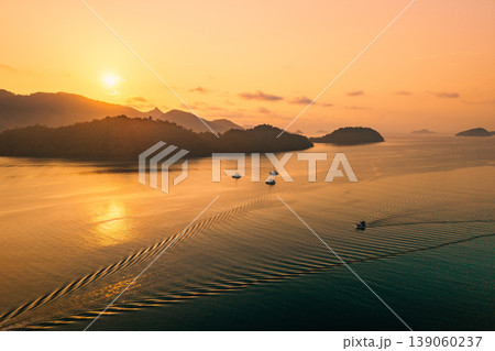 Drone landscape of sailing yachts and a small boat in the sea at sunset. Drone landscape of sailing yachts and a small boat in the sea at sunset. 139060237