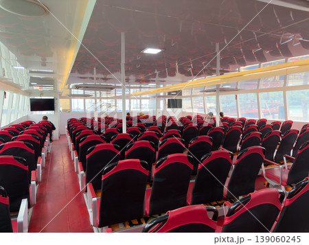 Empty rows of red passenger seats inside a modern transport ferry. Empty rows of red passenger seats inside a modern transport ferry. 139060245
