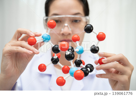 Scientist holding molecular model for chemical technology. Scientist holding molecular model for chemical technology. 139061776