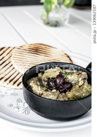 Roasted mashed Eggplant tapas snack on white table in outdoor restaurant in greece 139062397