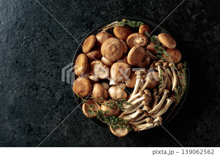 An assortment of mushrooms on a black table. An assortment of mushrooms on a black table. 139062562