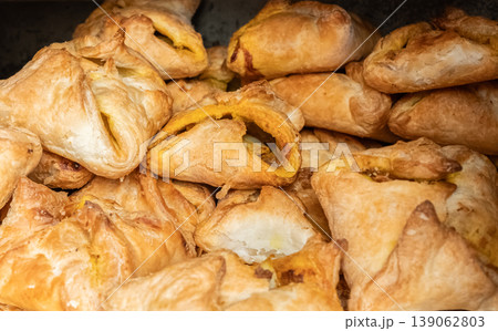 Cheese puffs stuffed with chicken or vegetables on display at street food market 139062803