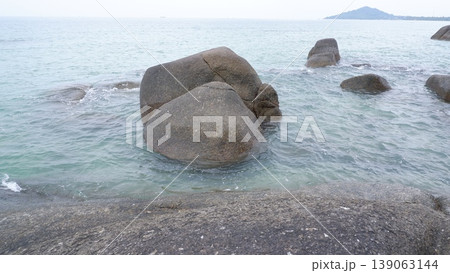 Sea Water Ripples Around Granite Rocks in the Morning 139063144